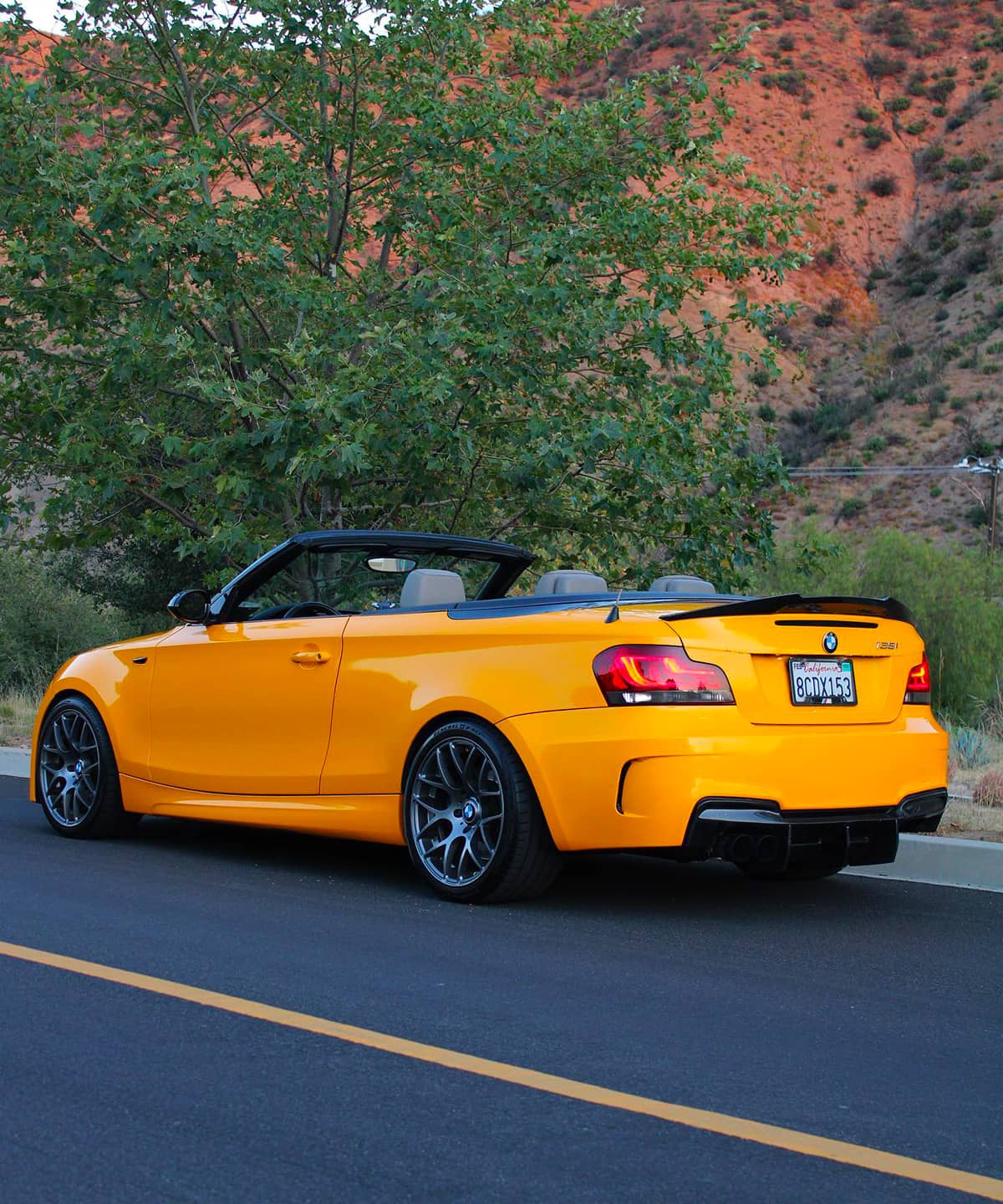 stanced BMW 135 1 series 1M convertible in yellow color