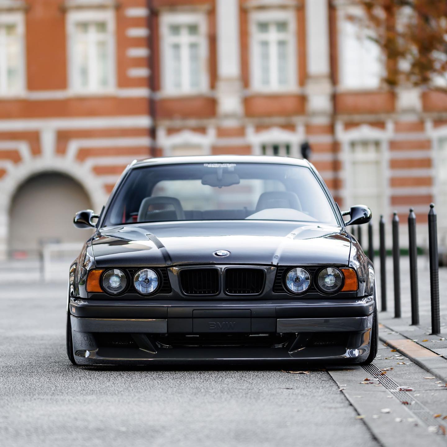 Dropped BMW E34 front end with amber turn signals and black smoke headlights