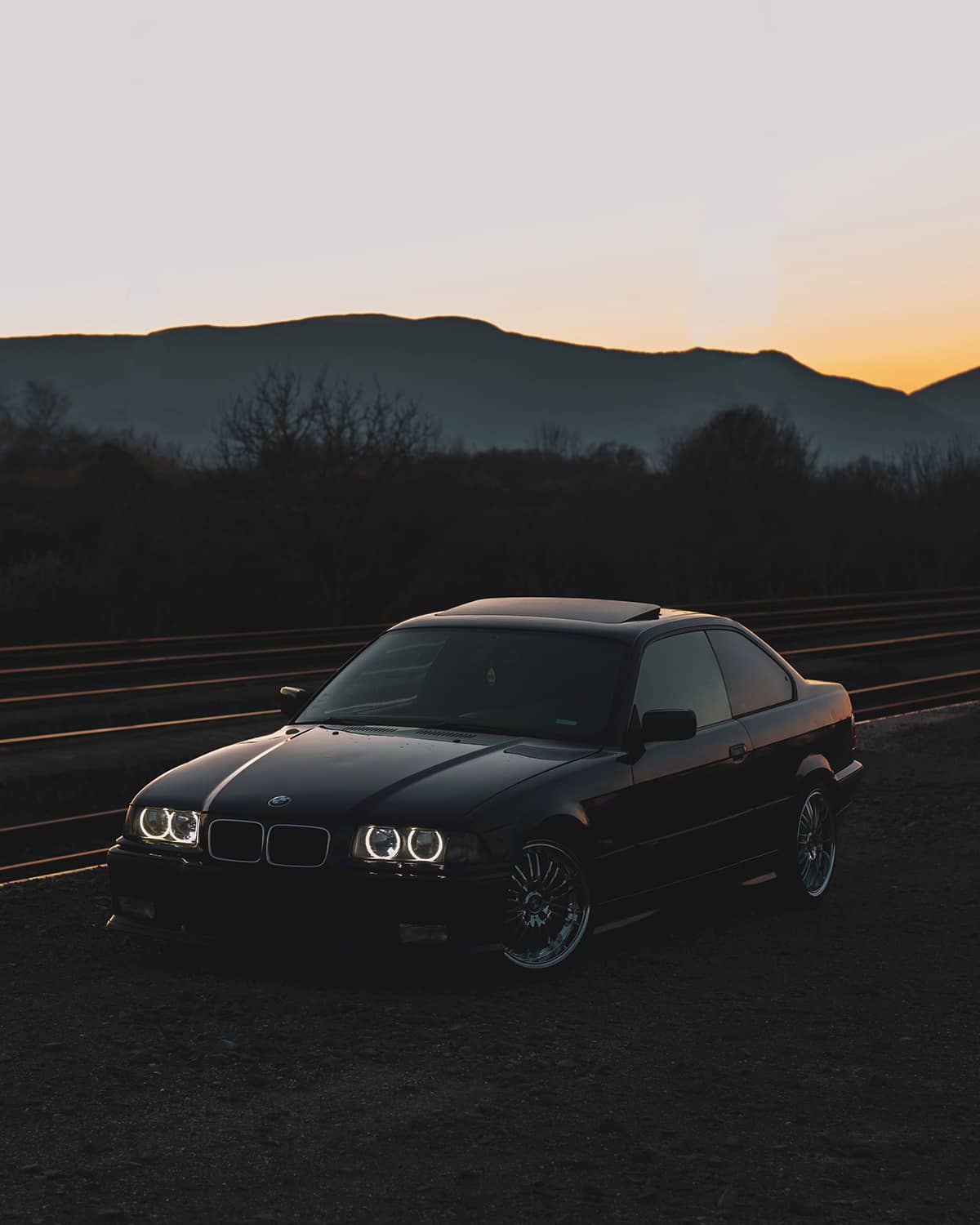 Black BMW E36 Coupe with LED halo rings circles in headlights